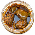 Handmade pickle in glass jar with mustard oil and spices, crafted traditionally